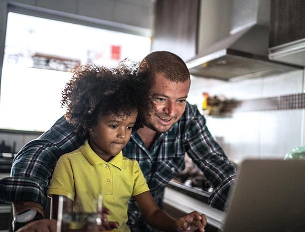 Man and child looking at computer